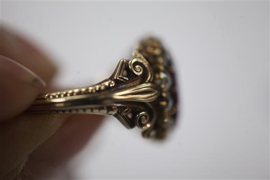 A 19th century gold rhodolite? garnet and rose cut diamond oval dress ring, size Q.